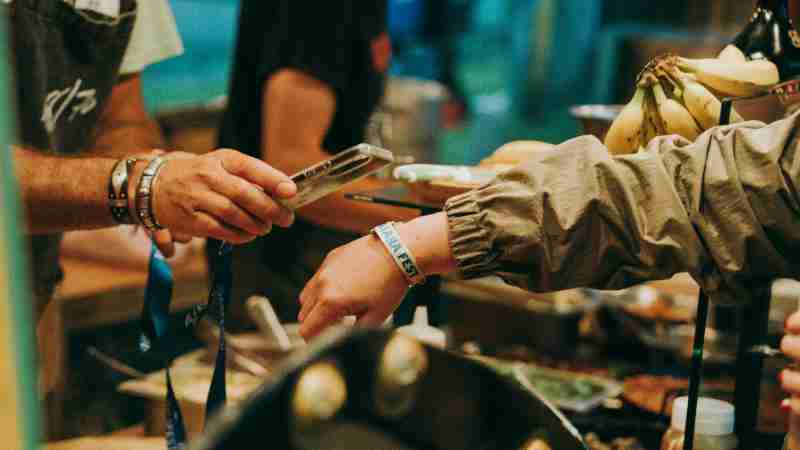 A lively festival food purchase transaction between vendor and customer., tags: tradition le - pexel